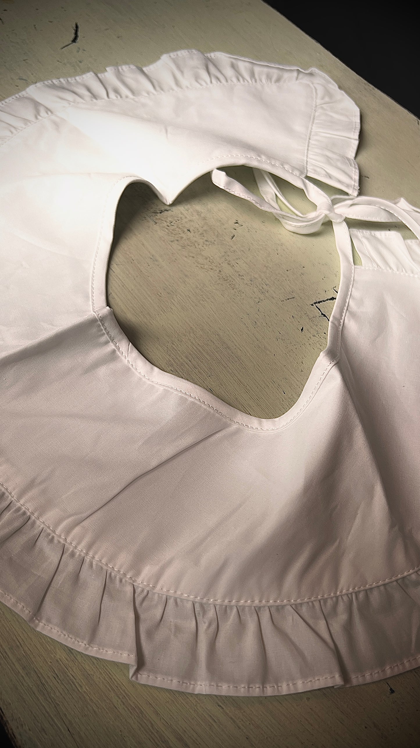 A delicate large white collar